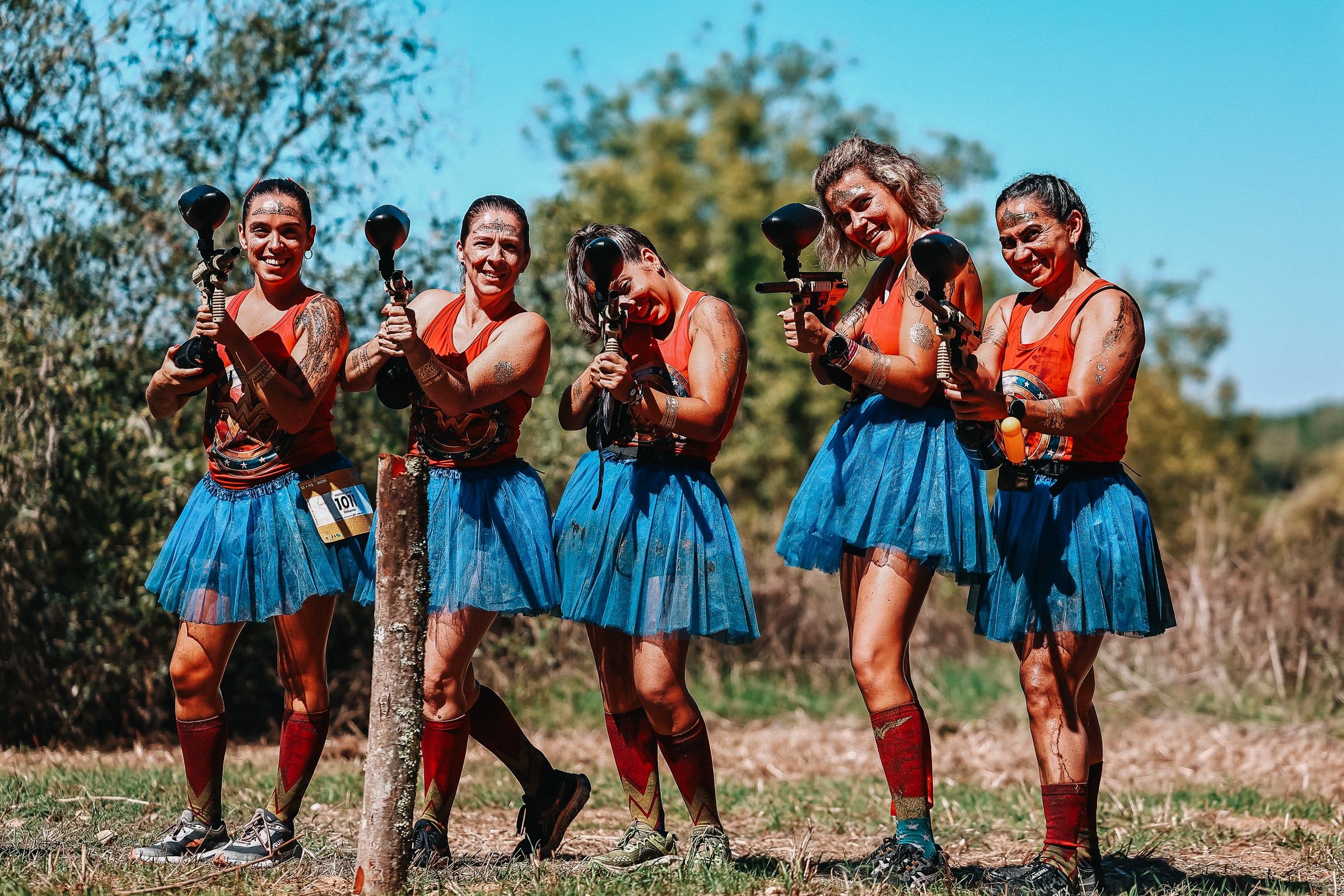 A costumed team in blue skirts with water pistols.