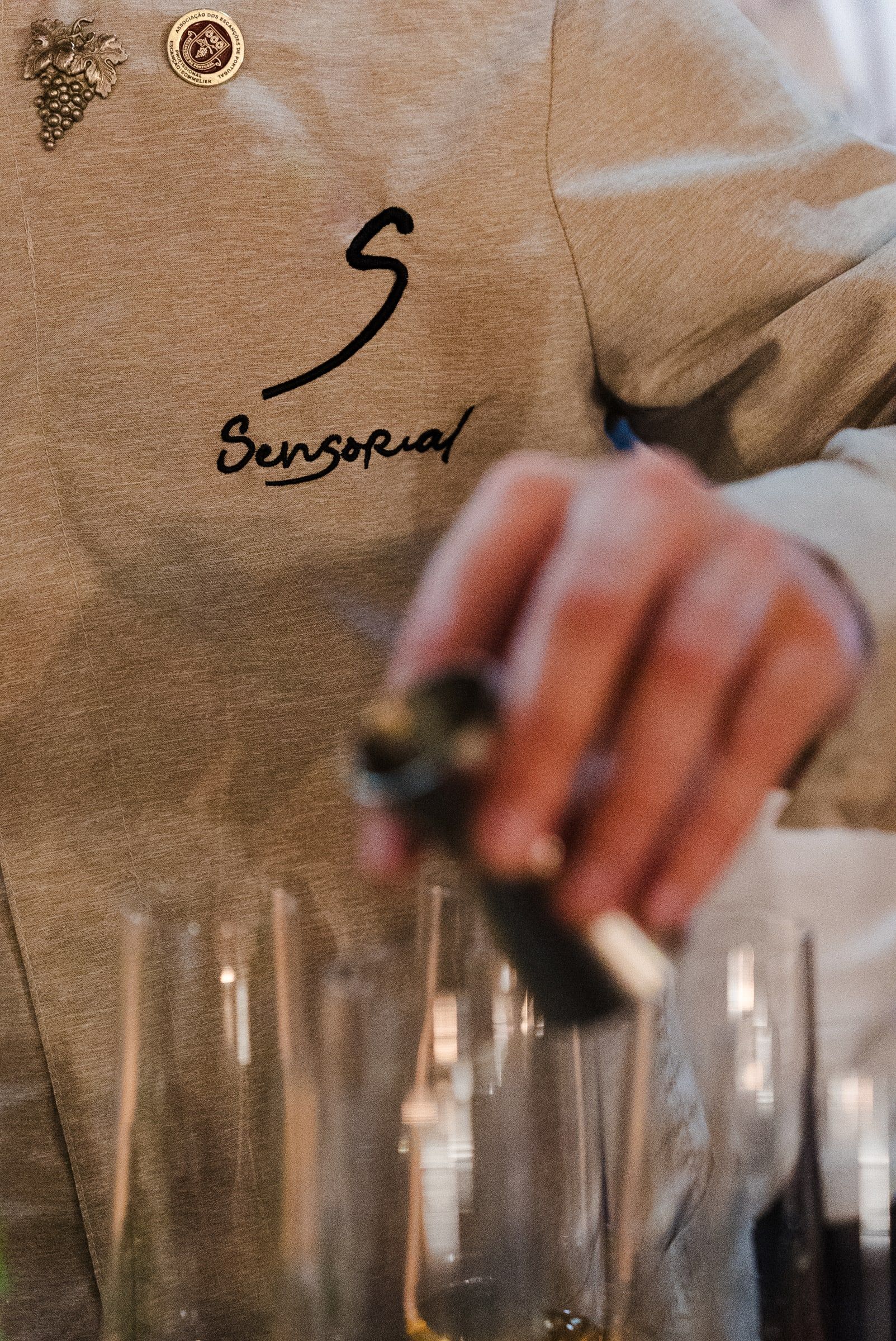 The S embroidered on the chef's jacket during service.