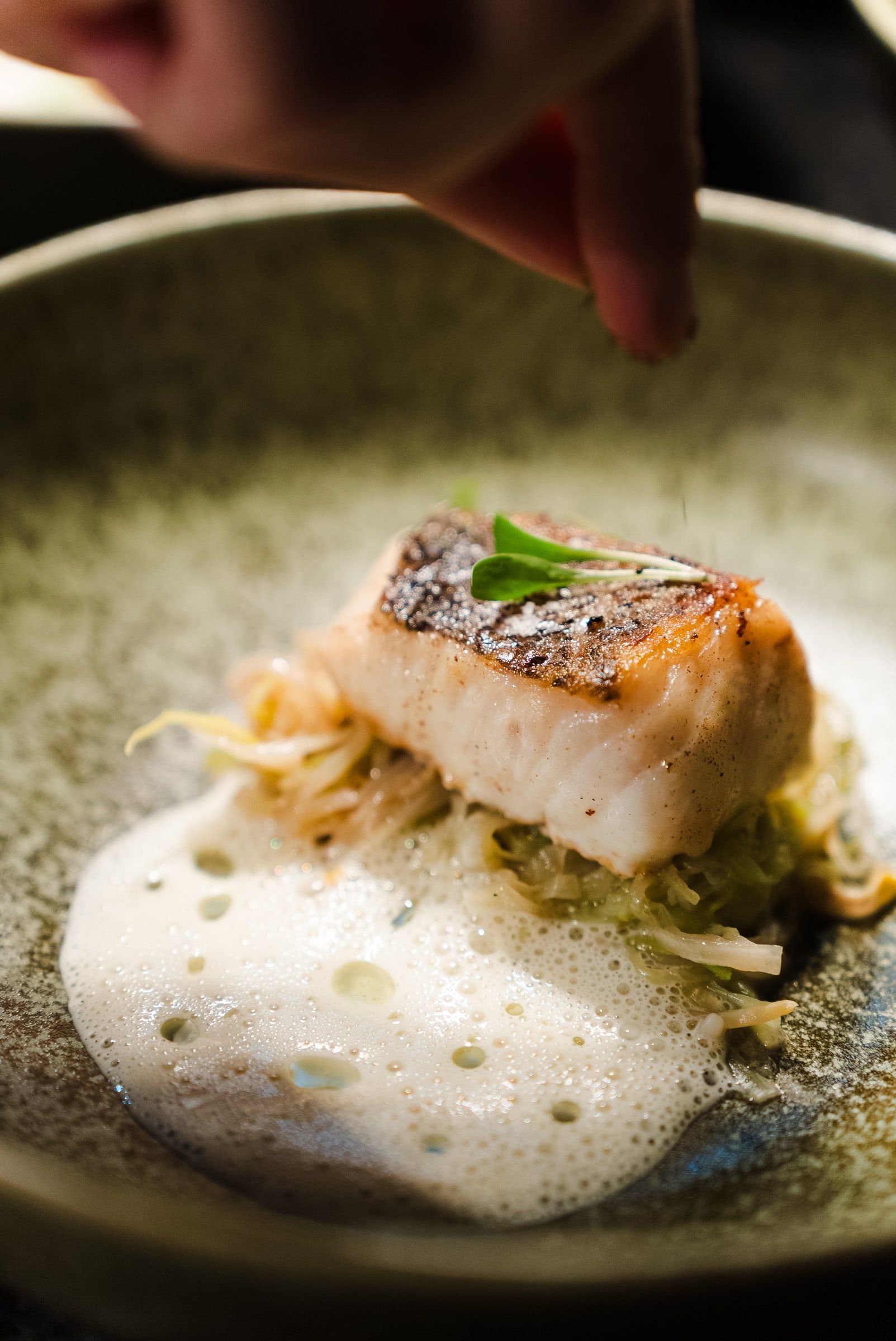 A dish being finished by hand.